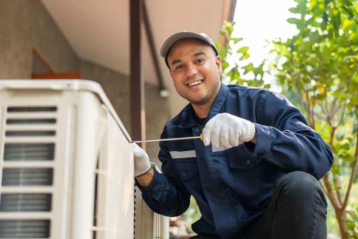 Technician repairing air conditioner on Hamilton